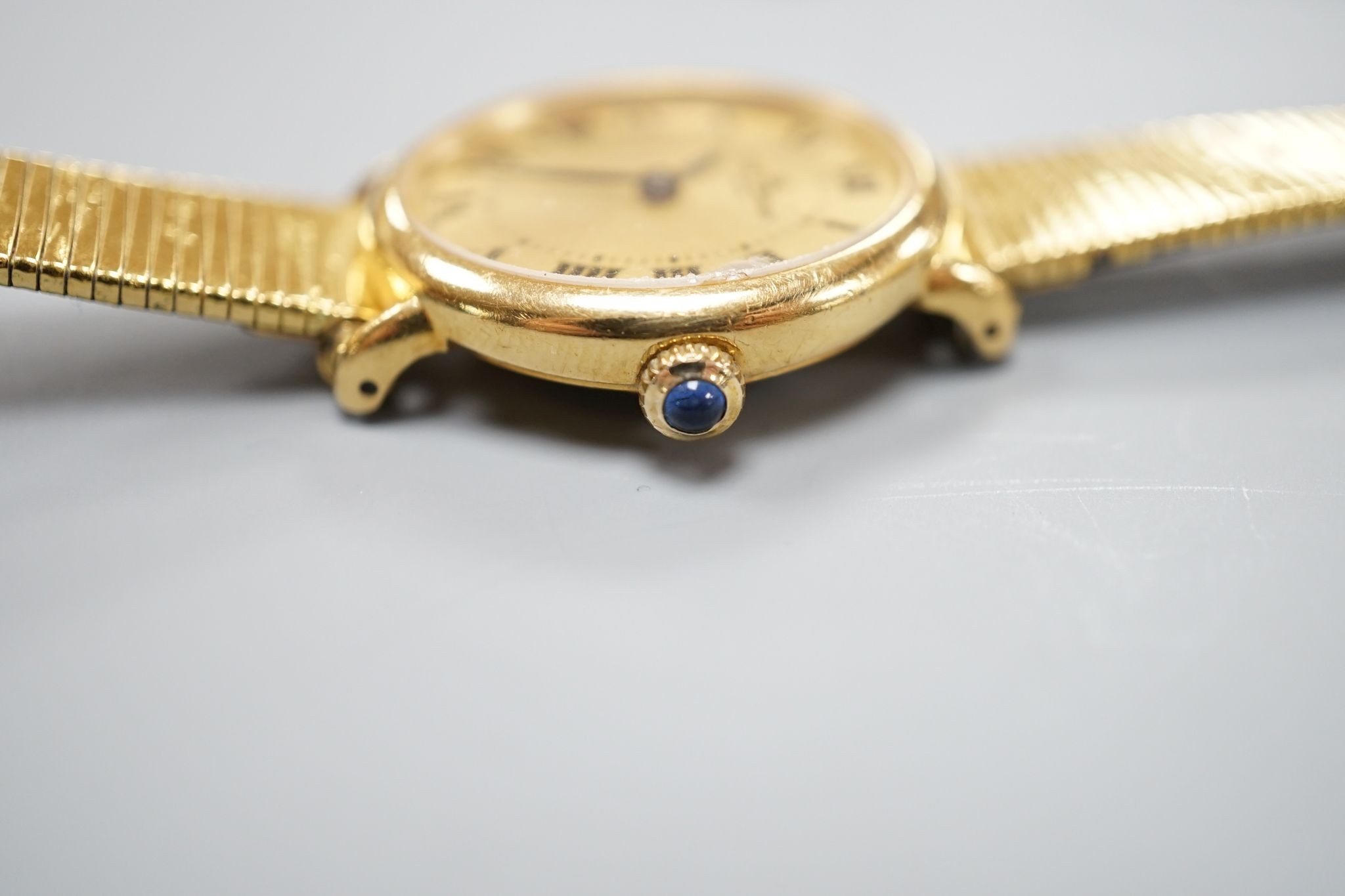 A lady's 18ct gold Baume & Mercier manual wind dress wrist watch, on an associated gold plated bracelet, case diameter 23mm, gross weight 28.3 grams.